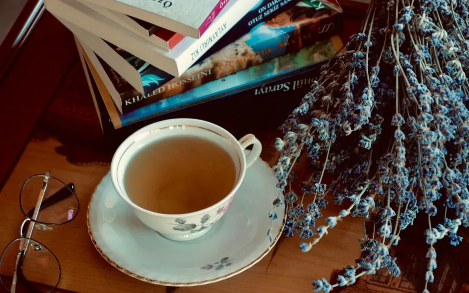 Table de travail avec carnet, livres et tasse de tisane